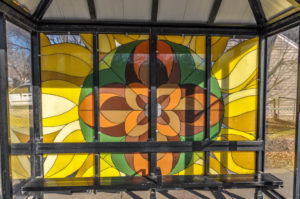 Abstract Sunflower design on Bus Shelter - north side of 21st Street North at Kansas - painted glass - artist(s) unknown 2010